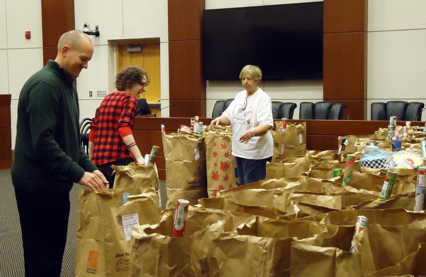 Volunteers check bags of gifts in the township boardroom