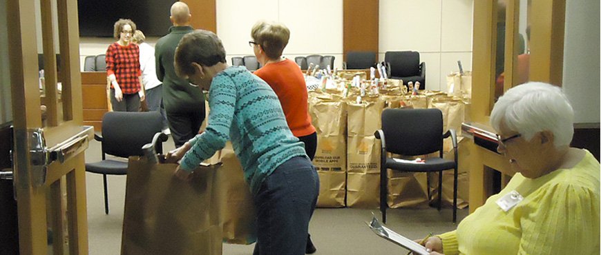 volunteers organize gifts and toys into bags